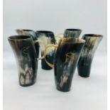 A Set of six horn drinking cups with handles and symbolic letters