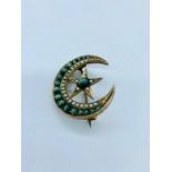 A Hungarian crescent shaped brooch with Cat Eyes and Seed Pearls in a gold setting