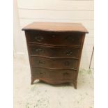 A Mahogany serpentine chest of drawers with four lockable drawers and original ornate brass handles