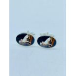 A Pair of silver cuff links with enamel panels depicting dogs