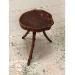 A Small three legged rustic style yew wood table