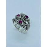 A Sterling silver snake ring with ruby cabochons