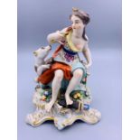 A 19th Century porcelain figure of a lady with a dog, with a gold anchor mark to base.