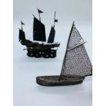 Two white metal sailing ships