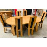 An Oval pine dining room table with six chairs with leather seats and backs