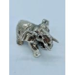 A sterling silver elephant with emerald eyes