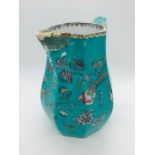 A Jade green Davenport jug with exotic birds and spout with face details AF