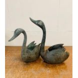 A Pair of weathered metal Swan garden plant holders