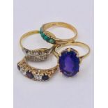 A selection of four 9ct yellow gold rings with various stones and settings