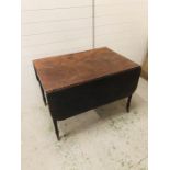 A Mahogany drop leaf dining table on reeded legs with brass castors (70cm X 149cm fully extended)