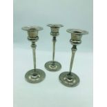 A Set of three silver plated candle sticks