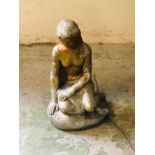 A Stone statue of a girl sitting on a rock (50cm tall)