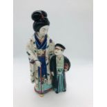 A Porcelain figurine of a Japanese women and child