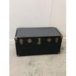 A Large blue travel trunk with decorative brass trimmings and leather handles (H50cm D50cm W103cm)