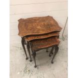 A Nest of three decorative walnut tables on cabriole legs