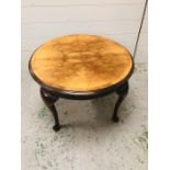 A Walnut coffee table on four cabriole legs with quarter topped veneer