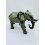 A 19th century style heavily cast bronze figure of an elephant