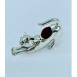 A silver leaping cat pin cushion with ruby eyes