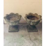 A Pair of stone plant pots on bases with leaf detailing (45cm tall)