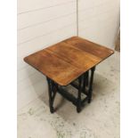 A Small walnut gateleg table on turned legs (H62cm D 31cm W56cm)