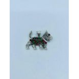 A Silver pendant in the form of a dog inset with rubies