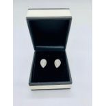 A Pair of 18ct white gold pear shaped diamond earrings of 1/2ct approx.