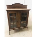 An Oak display cabinet on cabriole legs with glazed doors