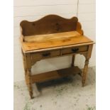 A double pine wash stand with two drawers on turned legs and lower shelf