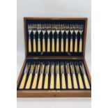 A 24 piece boxed set of silver plated fish knives and forks with keys