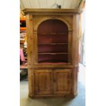 An Extremely large round backed pine corner cabinet with cupboard under and three shelves with
