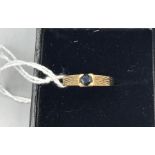 A 9ct Yellow gold and blue sapphire ring
