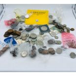A selection of loose coins and tokens predominately Great Britain, but some foreign as well.