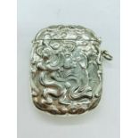A silver vesta case with embossed decoration in an art nouveau style
