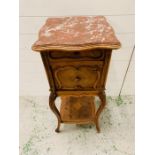 A pot cupboard with marble top and marble lined cupboard and relief moulded panel door