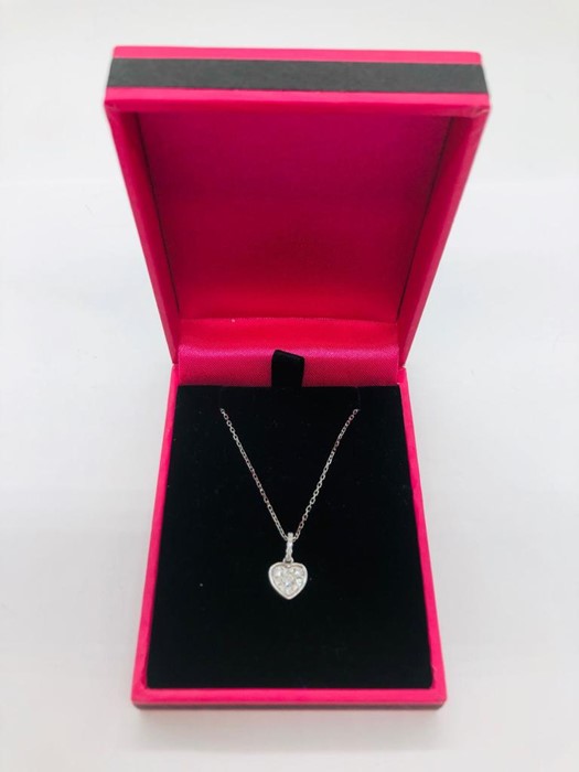 An 18ct white gold diamond heart shaped pendant necklace on gold chain 25 points