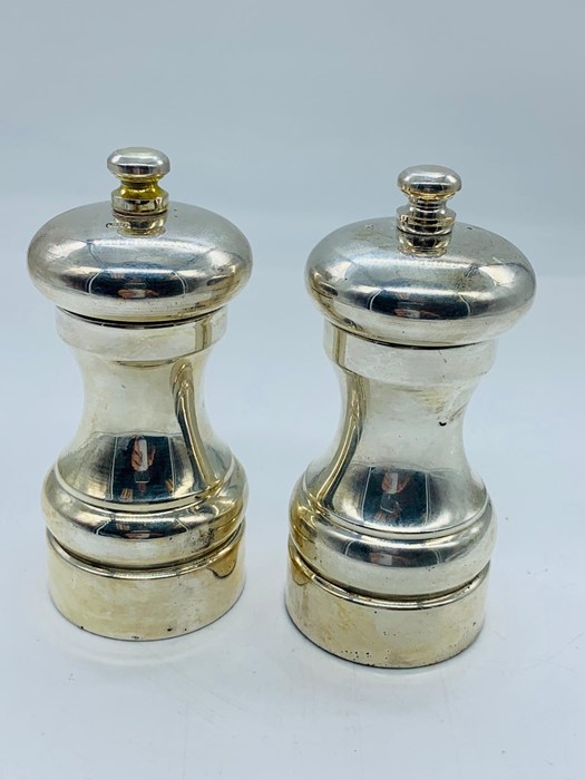 A silver salt and pepper set hallmarked for the year 2000 by maker MCH