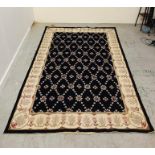 A Black and cream rug 261cm x 166cm.