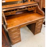 A roll top, pedestal desk.