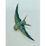 A silver and plique a jour brooch in the form of a bird