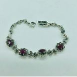 A silver cz and ruby panelled bracelet