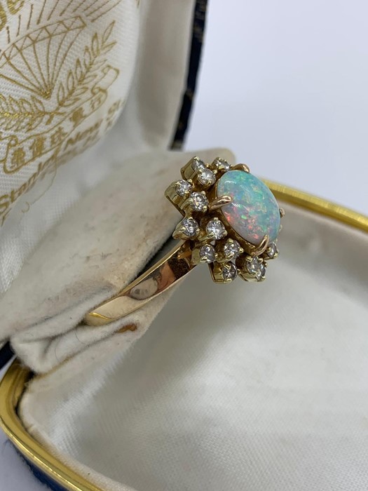 An opal and diamond cluster ring set with twenty diamonds. - Image 2 of 6