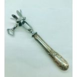 A silver handled lamb shank holder