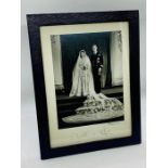 A framed Royal Photograph of Princess Elizabeth and Prince Phillip signed by both and also signed in