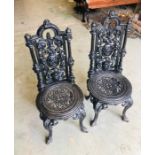 A Pair of small heavy cast iron chairs (96cm tall)