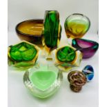 A collection of encased mid century glass items