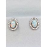 A pair of silver cz and opal panelled stud earrings