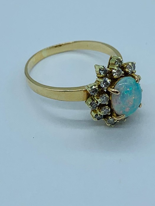 An opal and diamond cluster ring set with twenty diamonds. - Image 3 of 6