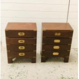 A pair of small mahogany bedside drawers with brass detailing to include four drawers