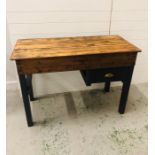 A rustic pine painted work bench/table