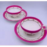 A Pair of pink and white cups and saucers with rope style handles and feet by Tc Brown Westhead